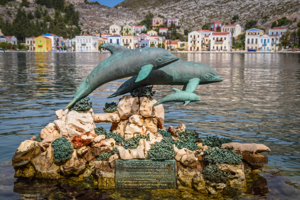 dolphins statue at kastelorizo harbor