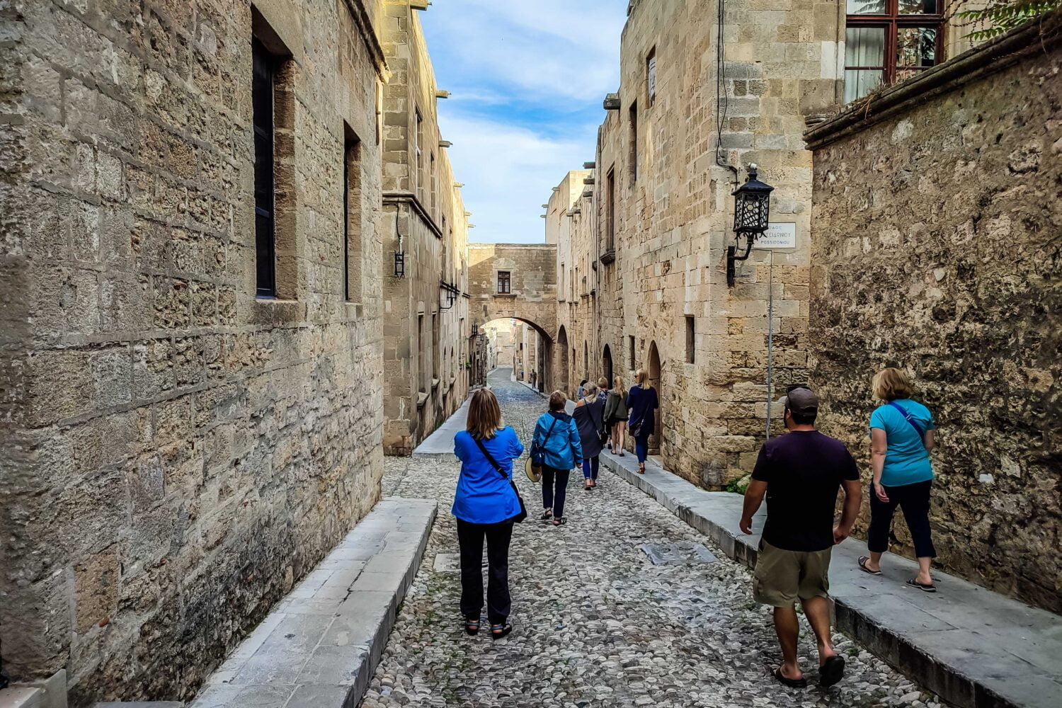 group of persons is walking down the street of the knights of Rhodes old town