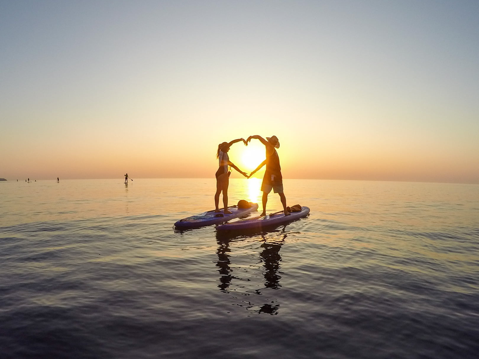 stand up paddle activity during sunset in rhodes island